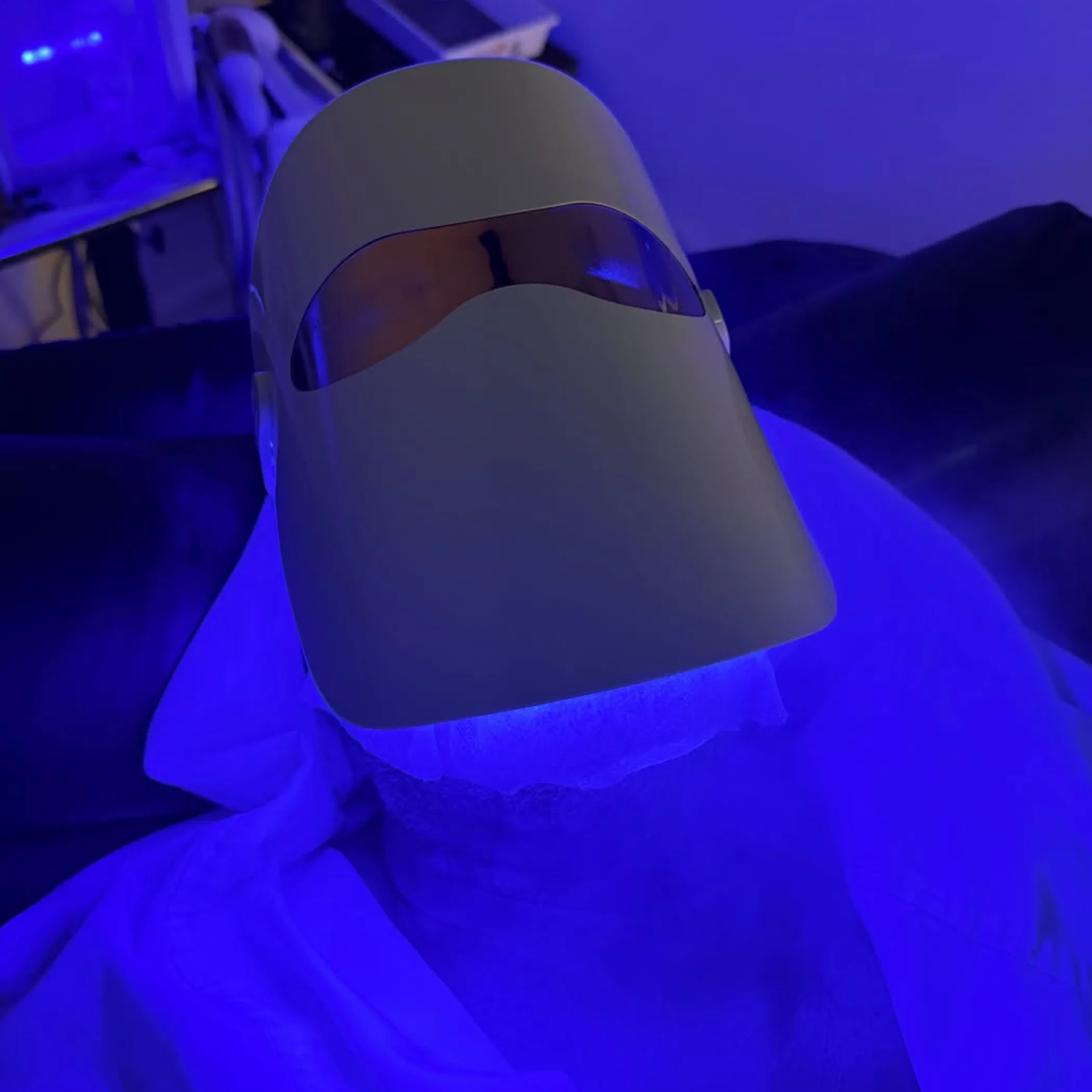 man receiving led light facial treatment