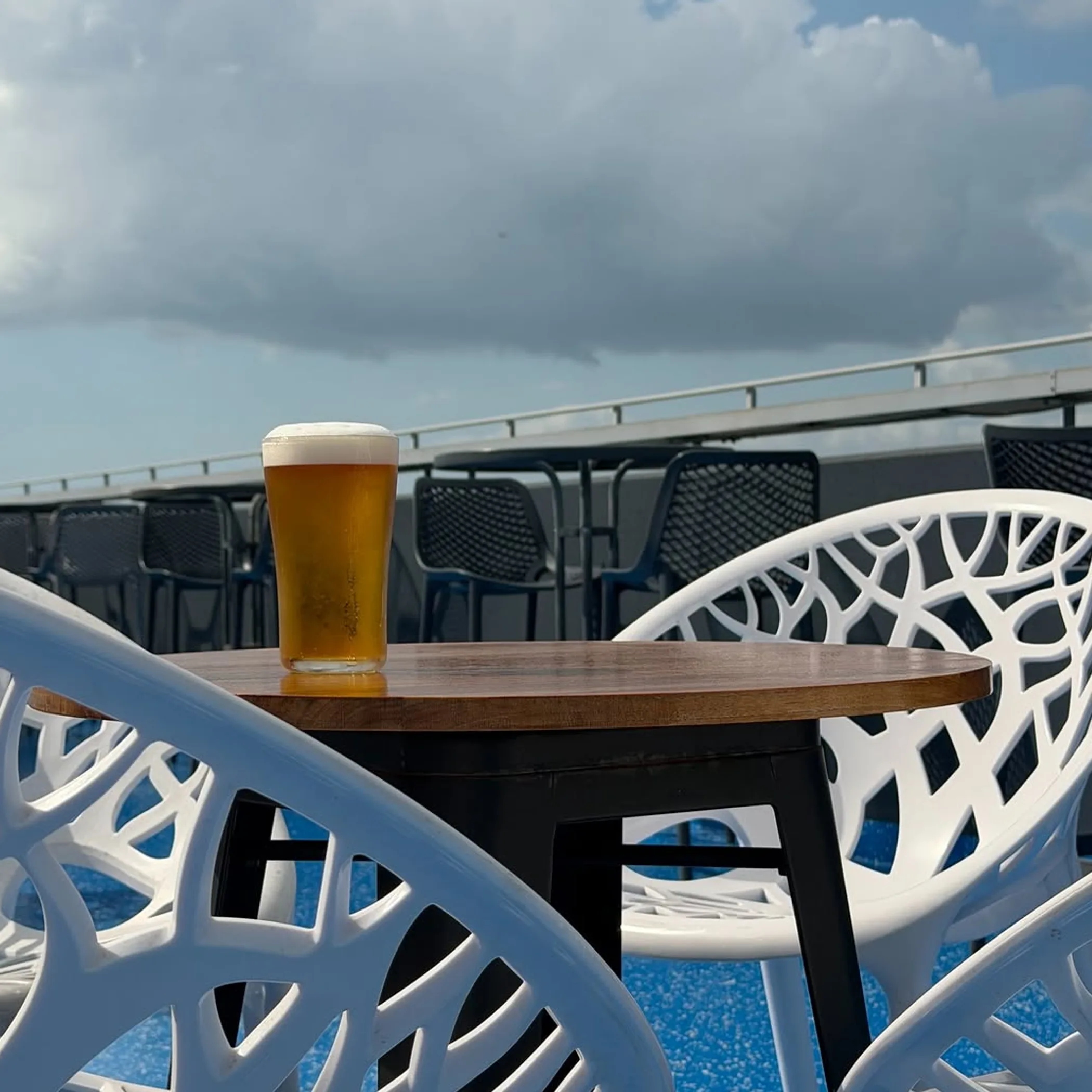 beer on rooftop table cloudy sky